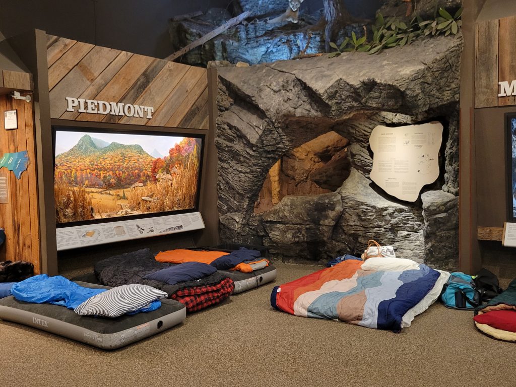 sleeping bags set up in NC Hall by the piedmont and cave display