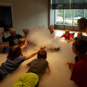 kids surrounding a cloud of fog
