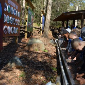 a line of kids doing gemstone mining at th Grist Mill