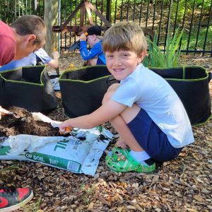 Boy gardens during summer camp