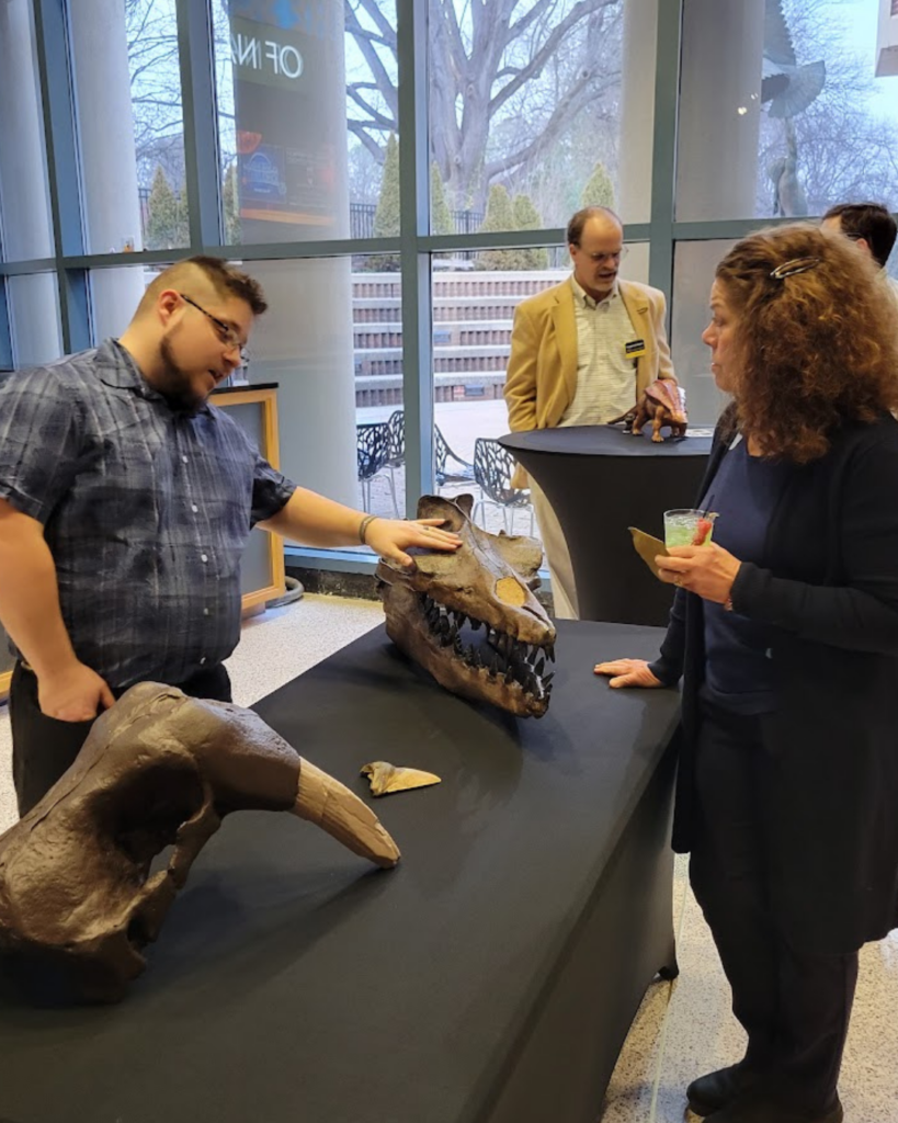 Paletontologist, Nick Brand, shows a skull to a visitor